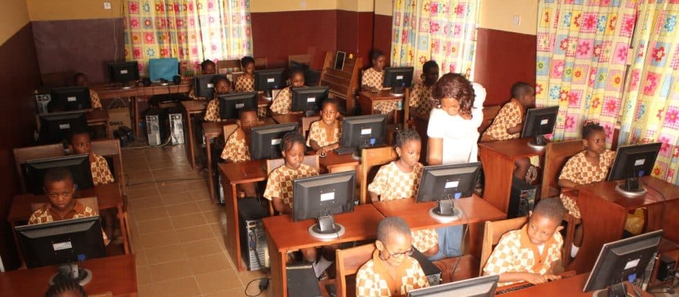 Pupils working at desktop computers in the B and B School computer room