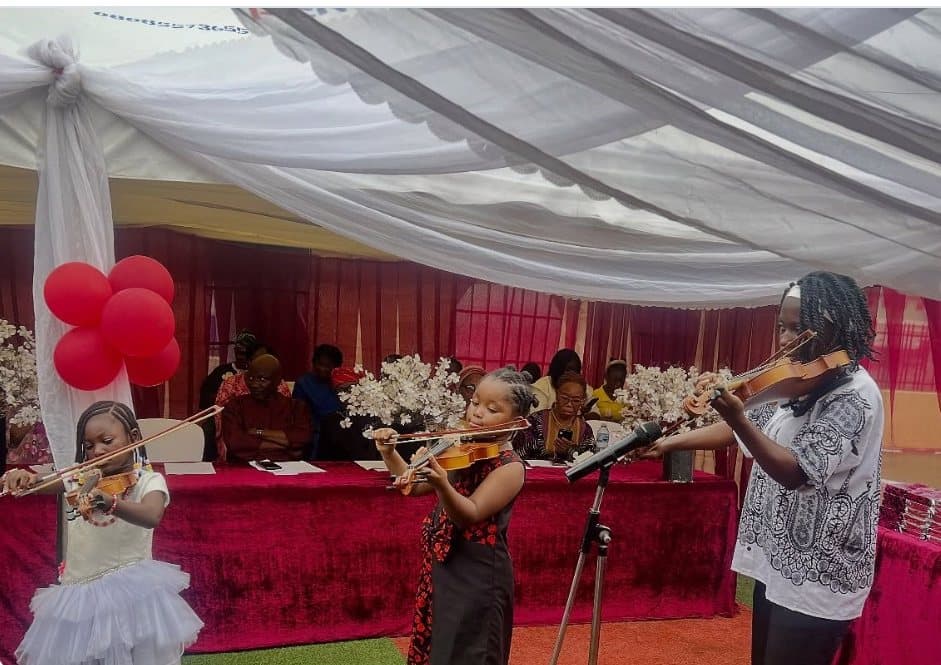 Three pupils playing violins at the Class of 2026 graduation ceremony