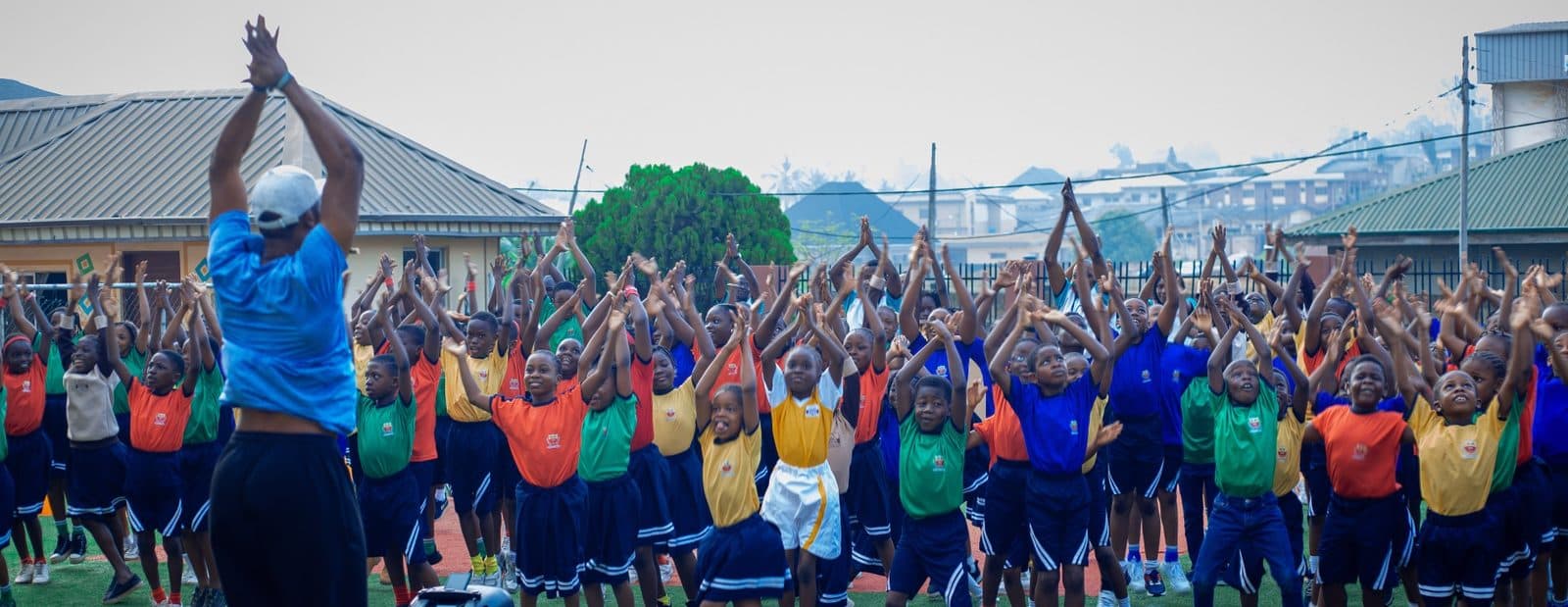 B and B School pupils doing morning exercises together on the school playground