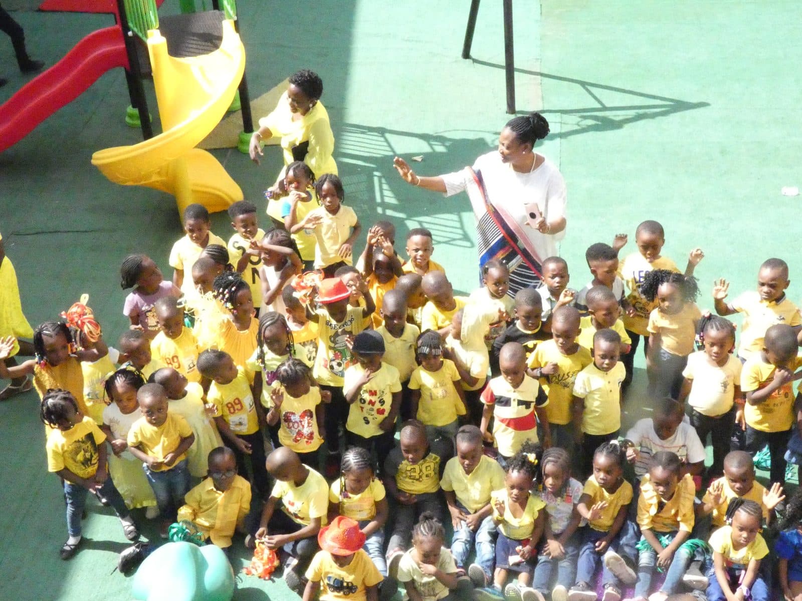 Nursery pupils in yellow gathered together on the school playground at Christmas time, December 2019