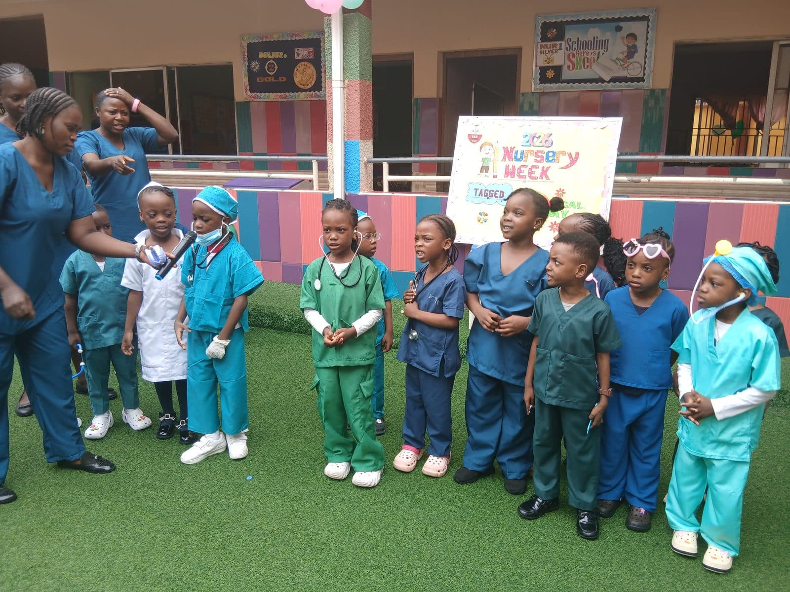 Nursery pupils in doctors' and nurses' scrubs lined up on the playground for Medical Day during Nursery Week, July 2026